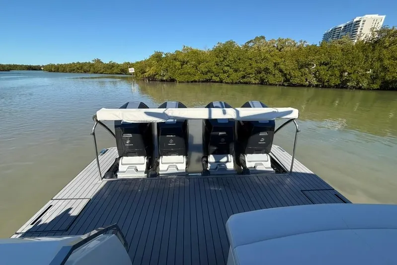  Yacht Photos Pics 2022 Formula 500 Super Sport Crossover boat with four outboard engines on a calm waterway.