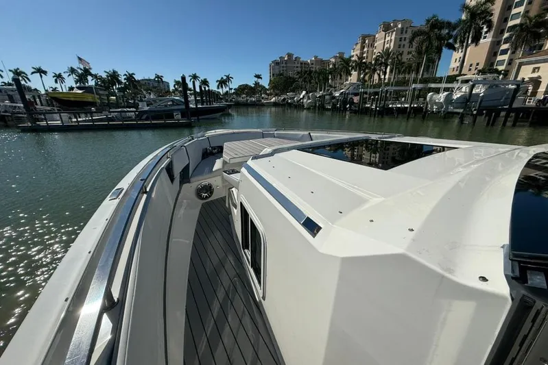  Yacht Photos Pics 2022 Formula 500 Super Sport Crossover yacht docked in sunny marina with palm trees.
