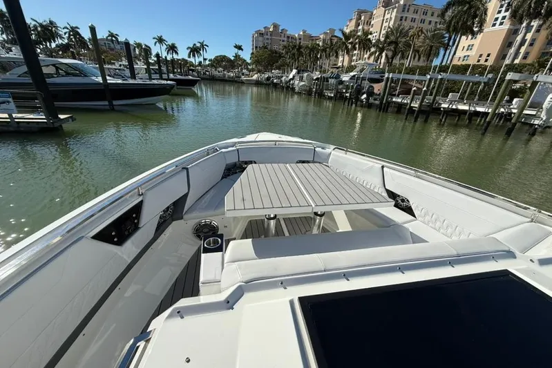  Yacht Photos Pics 2022 Formula 500 Super Sport Crossover boat docked in a marina with palm trees.