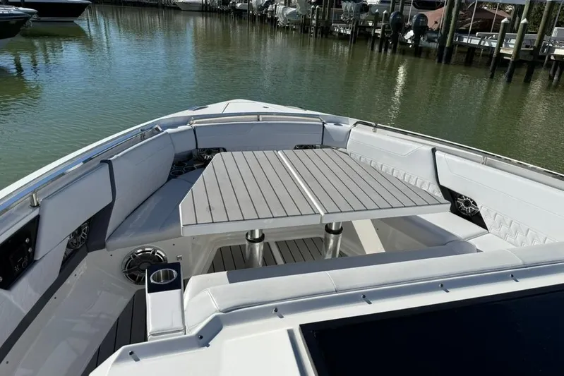  Yacht Photos Pics 2022 Formula 500 Super Sport Crossover boat with spacious seating and table on deck.