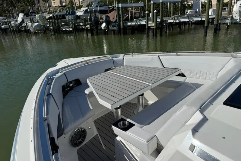  Yacht Photos Pics 2022 Formula 500 Super Sport Crossover boat with spacious seating and table on deck.
