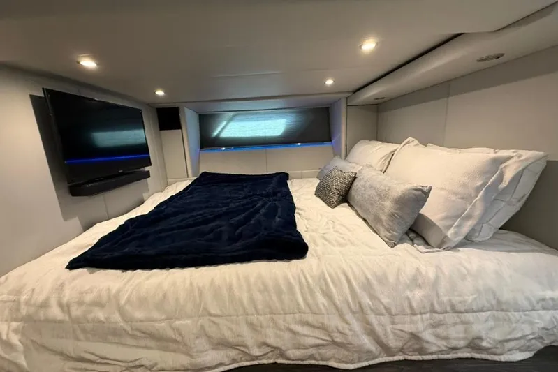  Yacht Photos Pics Luxurious cabin interior of 2022 Formula 500 Super Sport Crossover with cozy bedding and TV.
