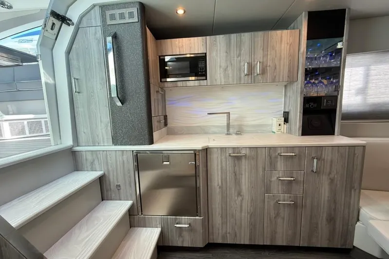  Yacht Photos Pics Modern kitchen interior in 2022 Formula 500 Super Sport Crossover boat, featuring sleek cabinetry and appliances.