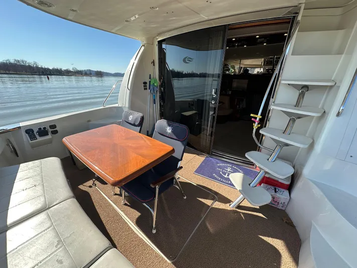  Yacht Photos Pics 2005 Carver 56 Voyager yacht interior with seating and table, overlooking serene water.