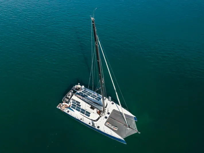 Flash Yacht Photos Pics 2017 HH Catamarans HH66 sailing on calm blue waters, aerial view.