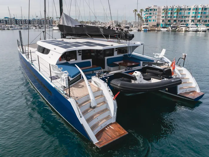Flash Yacht Photos Pics 2017 HH Catamarans HH66 luxury yacht with tender, docked in a marina.