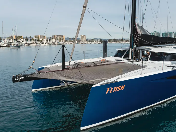 Flash Yacht Photos Pics 2017 HH Catamarans HH66 sailing catamaran in marina, featuring sleek blue hull and modern design.
