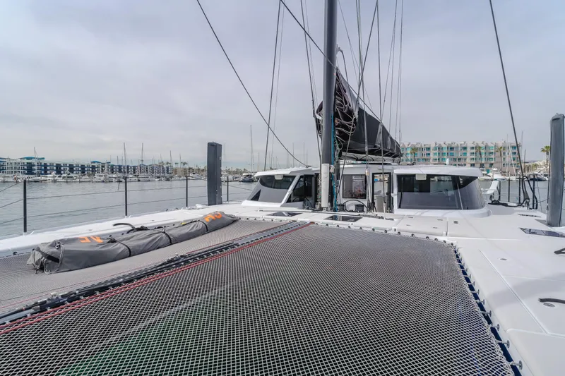 Flash Yacht Photos Pics 2017 HH Catamarans HH66 yacht with netted deck, docked in marina.