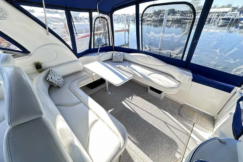 Yacht Photos Pics Interior of 2000 Sea Ray 410 Sundancer yacht with white seating and marina view.