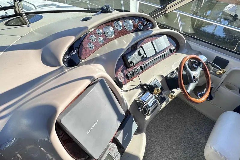  Yacht Photos Pics Control panel of a 2000 Sea Ray 410 Sundancer boat with steering wheel and gauges.