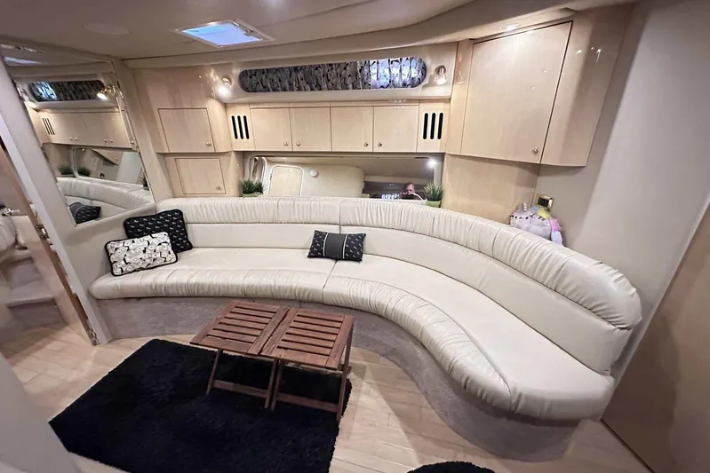  Yacht Photos Pics Luxurious interior of 2000 Sea Ray 410 Sundancer with curved seating and wooden accents.