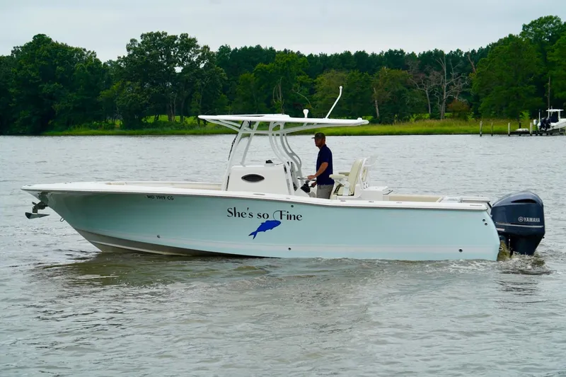 Yacht Photos Pics 2015 Southport 29 FE boat cruising on a calm river with lush green trees.