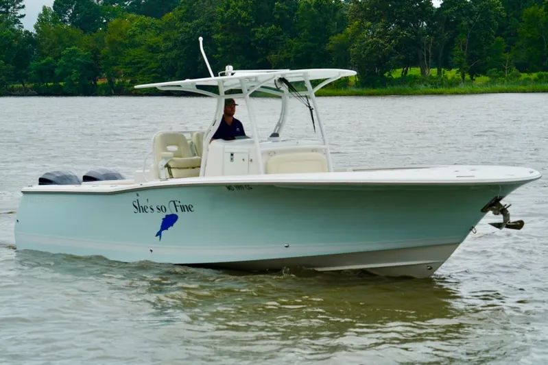  Yacht Photos Pics 2015 Southport 29 FE boat on water, named "She's so Fine," with lush greenery in background.