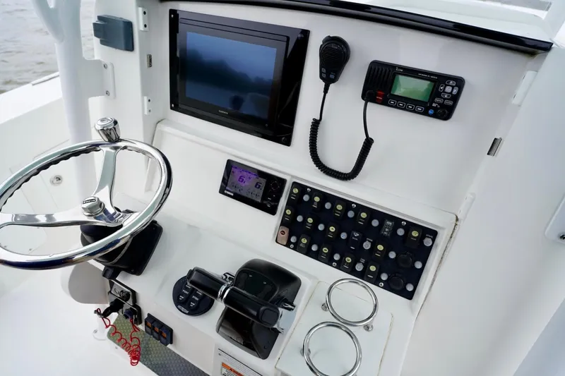  Yacht Photos Pics Control panel of 2015 Southport 29 FE boat with steering wheel and electronics.