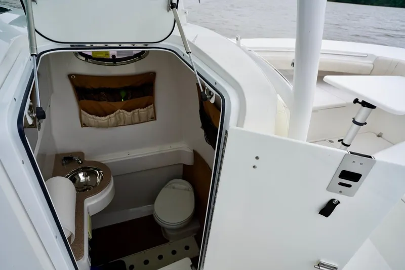  Yacht Photos Pics 2015 Southport 29 FE boat interior with compact bathroom and sink.
