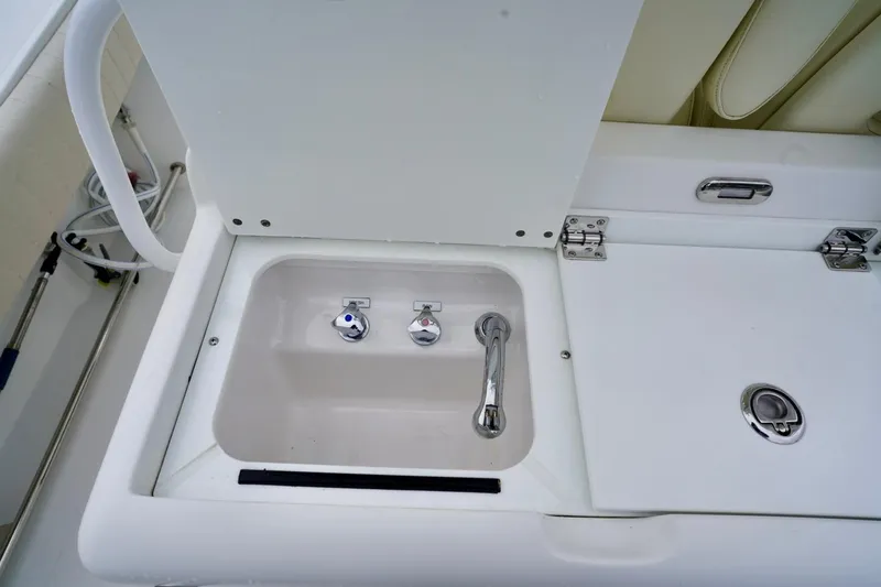  Yacht Photos Pics 2015 Southport 29 FE boat sink with chrome fixtures and storage compartment.