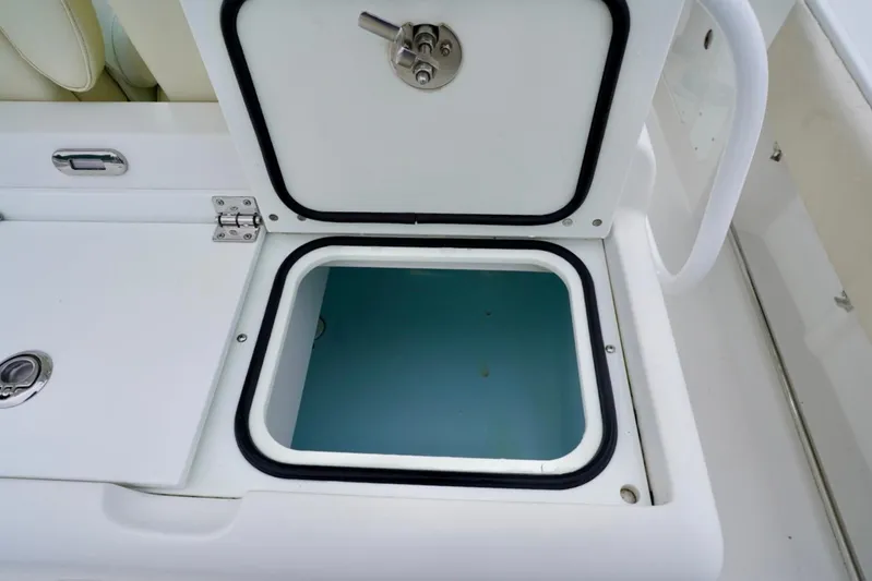 Yacht Photos Pics Open storage compartment on 2015 Southport 29 FE boat, featuring secure latch.