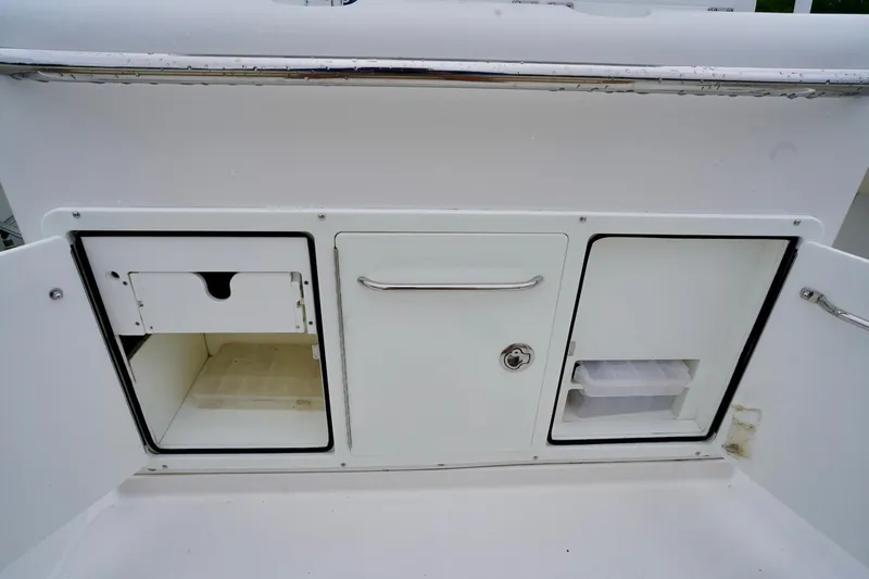  Yacht Photos Pics Storage compartments on a 2015 Southport 29 FE boat, featuring sleek white design.
