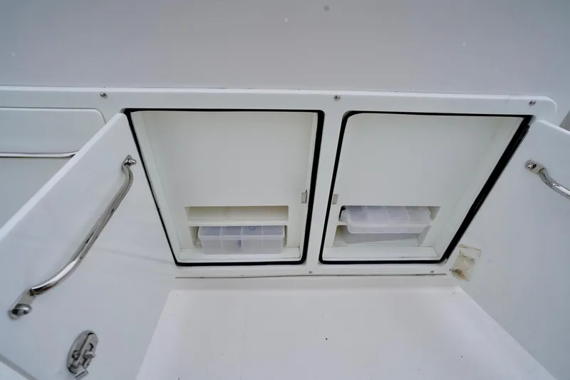  Yacht Photos Pics Storage compartments on a 2015 Southport 29 FE boat, featuring stainless steel handles.