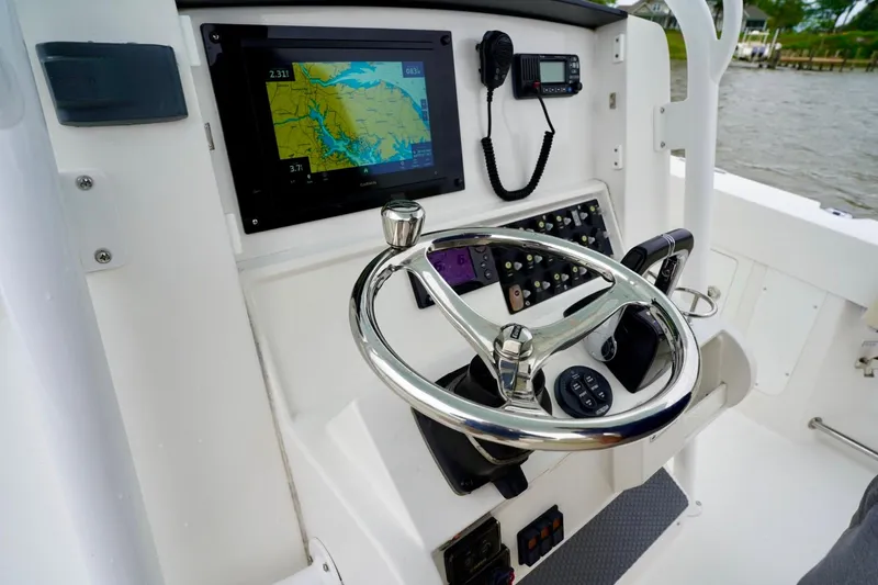  Yacht Photos Pics Control panel of a 2015 Southport 29 FE boat with navigation display and steering wheel.