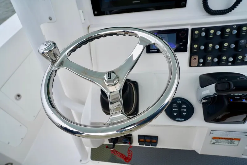  Yacht Photos Pics Steering wheel and controls of 2015 Southport 29 FE boat cockpit.