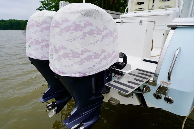  Yacht Photos Pics Twin outboard motors on a 2015 Southport 29 FE boat, covered with protective camo covers.