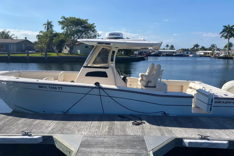  Yacht Photos Pics 2024 Grady-White Canyon 306 boat docked by a scenic waterfront.