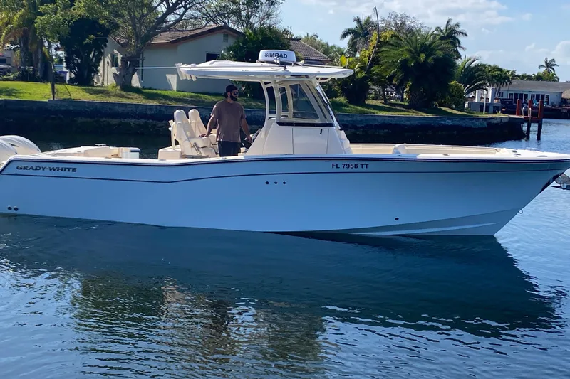  Yacht Photos Pics 2024 Grady-White Canyon 306 boat on calm water, side view.