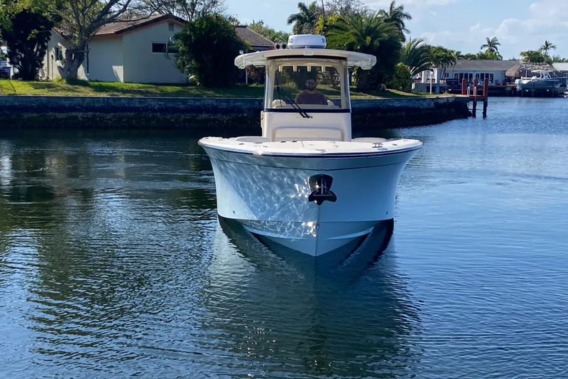  Yacht Photos Pics 2024 Grady-White Canyon 306 boat cruising on a calm waterway.