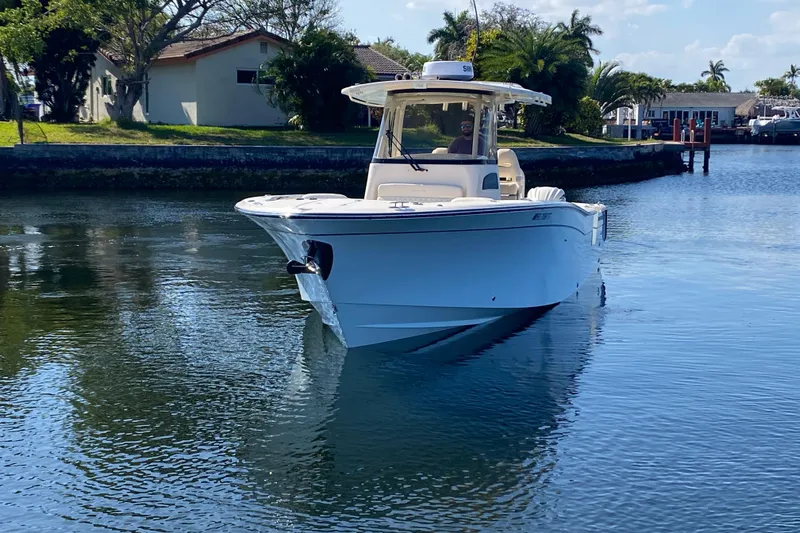  Yacht Photos Pics 2024 Grady-White Canyon 306 boat cruising on a calm waterway.