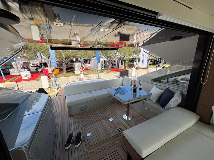  Yacht Photos Pics Luxurious 2025 Filippetti S55 yacht interior with elegant seating and table setup.