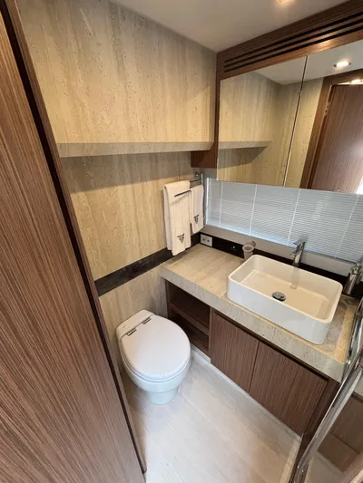  Yacht Photos Pics Luxurious bathroom in 2025 Filippetti S55 yacht with modern fixtures and elegant wood finishes.
