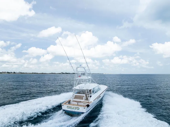 Ohayo Yacht Photos Pics 2010 Viking 52 Open yacht cruising on open sea under cloudy sky.