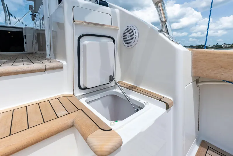 Ohayo Yacht Photos Pics 2010 Viking 52 Open yacht deck with built-in storage compartment and wooden accents.