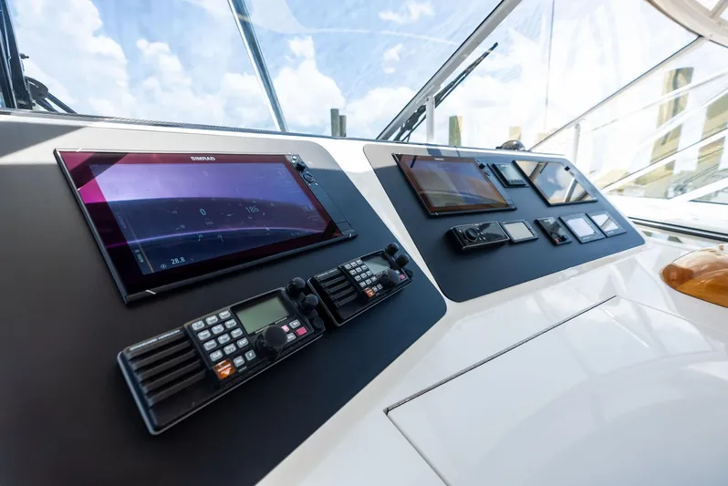 Ohayo Yacht Photos Pics Control panel of 2010 Viking 52 Open yacht with navigation screens and communication devices.