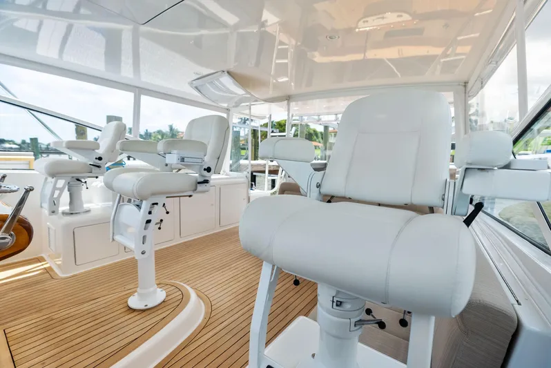 Ohayo Yacht Photos Pics Luxurious interior of 2010 Viking 52 Open yacht with white seating and wooden flooring.