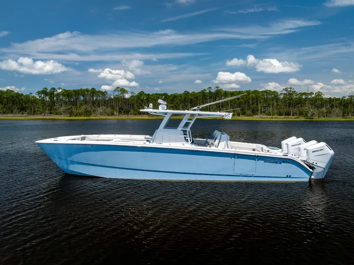  Yacht Photos Pics 2024 Invincible 37 Catamaran on calm water, showcasing sleek design and powerful engines.