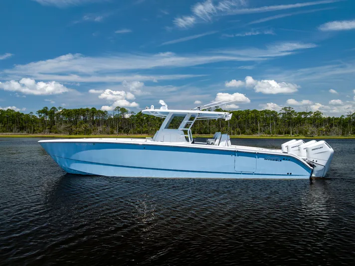  Yacht Photos Pics 2024 Invincible 37 Catamaran in calm waters, showcasing sleek design and powerful engines.