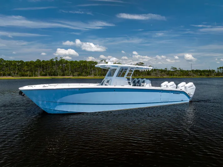  Yacht Photos Pics 2024 Invincible 37 Catamaran on water, showcasing sleek design and powerful engines.