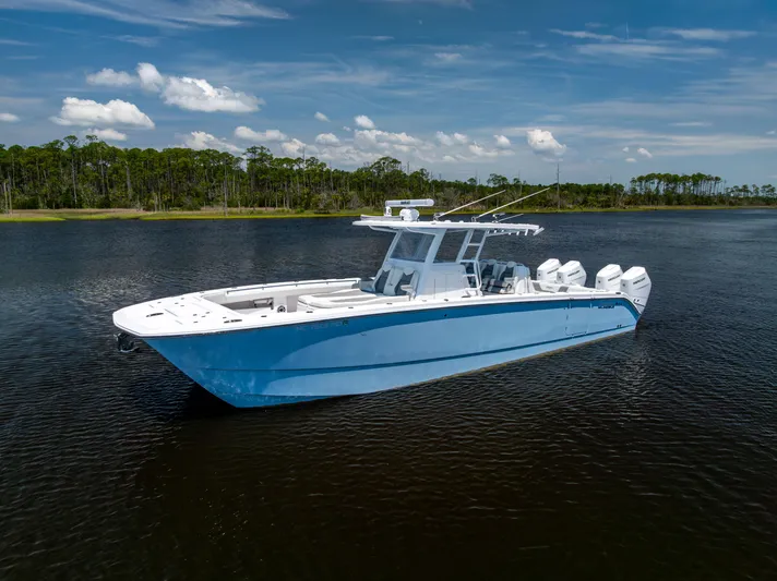  Yacht Photos Pics 2024 Invincible 37 Catamaran on calm water, showcasing sleek design and powerful engines.