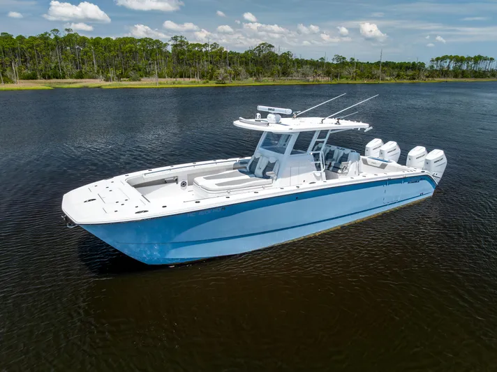  Yacht Photos Pics 2024 Invincible 37 Catamaran on calm water, showcasing sleek design and powerful engines.