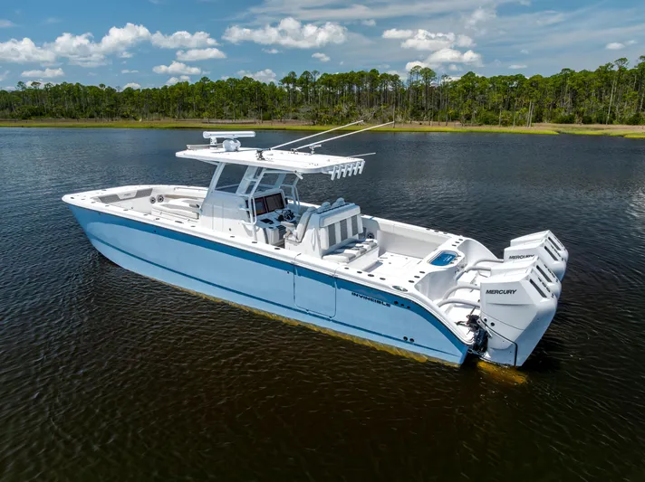  Yacht Photos Pics 2024 Invincible 37 Catamaran on calm water, featuring sleek design and powerful Mercury engines.