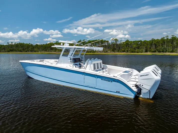  Yacht Photos Pics 2024 Invincible 37 Catamaran on calm water, showcasing sleek design and powerful engines.