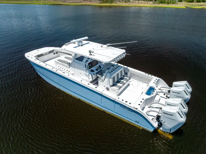  Yacht Photos Pics 2024 Invincible 37 Catamaran with triple Mercury engines on calm water.