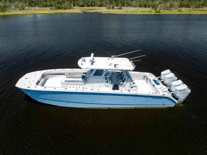  Yacht Photos Pics 2024 Invincible 37 Catamaran on calm water, showcasing sleek design and powerful engines.