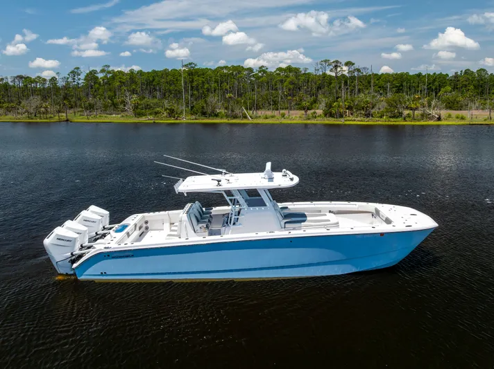  Yacht Photos Pics 2024 Invincible 37 Catamaran on calm water, showcasing sleek design and powerful engines.