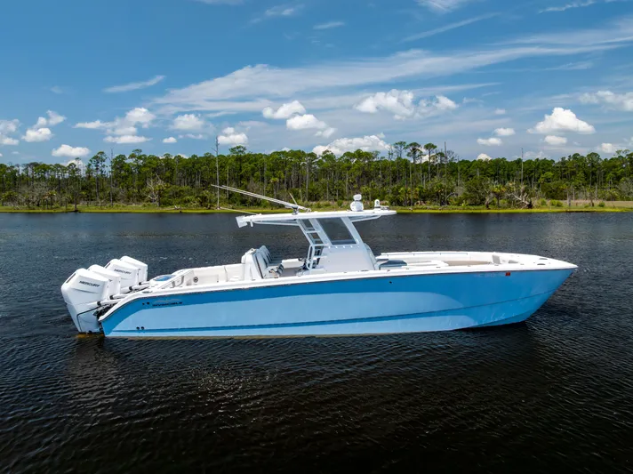  Yacht Photos Pics 2024 Invincible 37 Catamaran on calm water, clear sky background.