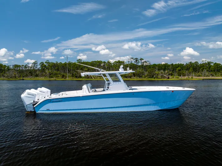  Yacht Photos Pics 2024 Invincible 37 Catamaran on calm water, showcasing sleek design and powerful engines.