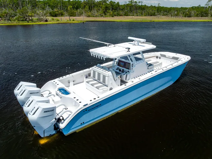  Yacht Photos Pics 2024 Invincible 37 Catamaran on water, featuring triple Mercury engines.