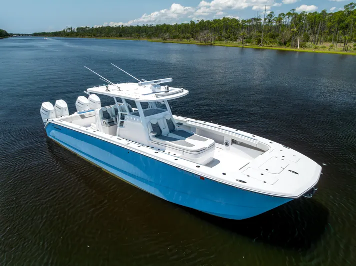  Yacht Photos Pics 2024 Invincible 37 Catamaran in calm waters, showcasing sleek design and powerful engines.